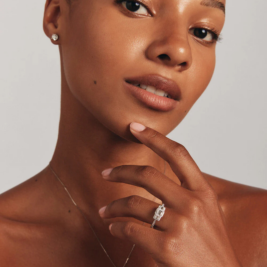 0.80 Carat TW Three Stone Emerald Cut Halo Engagement Ring in 14kt White Gold