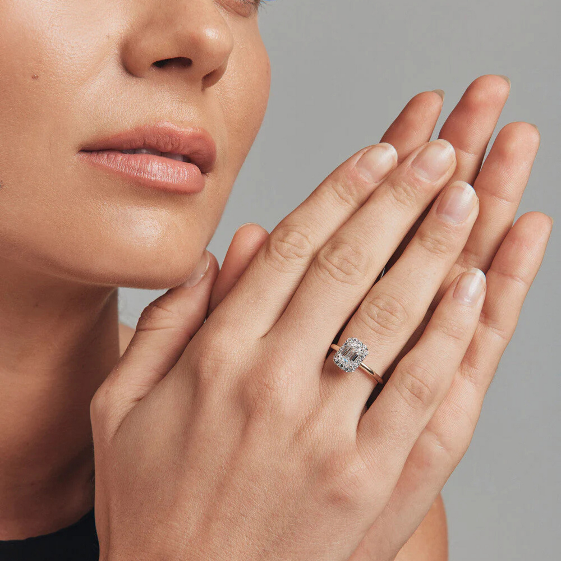 1.46 Carat TW Emerald Cut Laboratory-Grown Diamond Halo Engagement Ring on model's hand